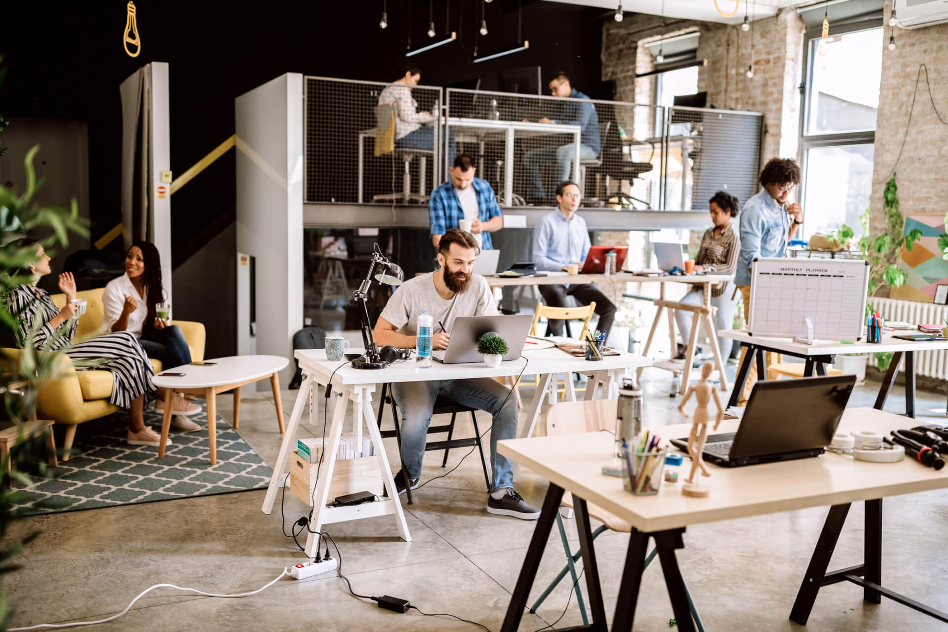 Satisfied Freelance Workers Working Together in Coworking Space