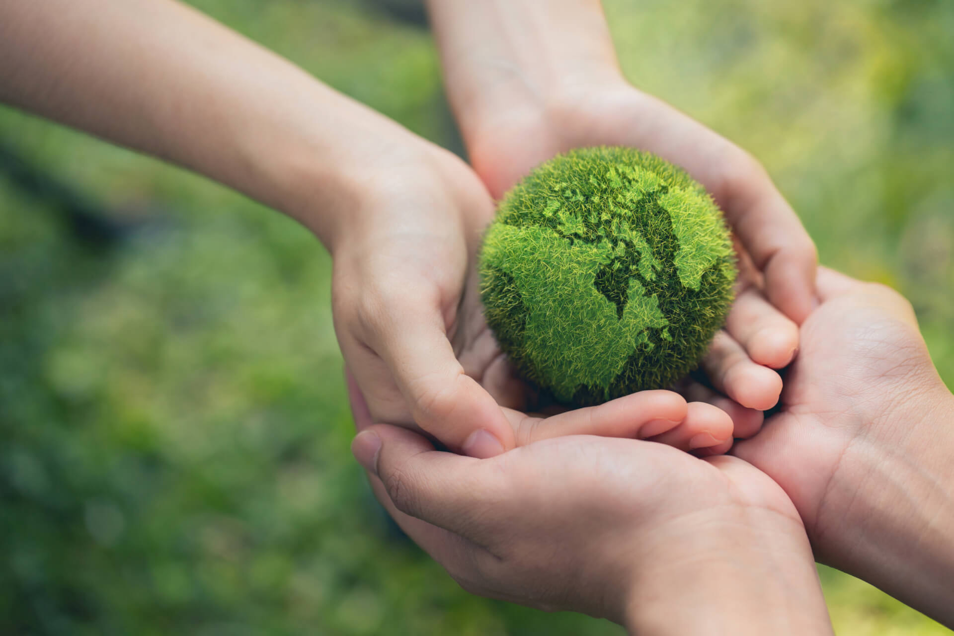 In the hands holding green earth on Bokeh green Background, Saving environment, and environmentally sustainable. Save Earth. Concept of the Environment World Earth Day