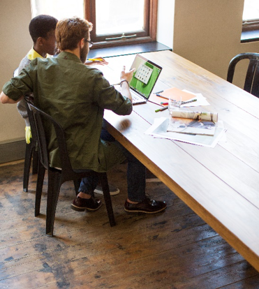 Two men collaborating to build a network lab.